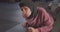 Closeup portrait of young determined athletic muslim female in hijab doing plank exercise in gym indoors