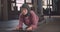 Closeup portrait of young determined athletic muslim female in hijab doing plank exercise training in gym indoors