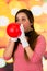 Closeup portrait of young girl clown mime blowing a balloon