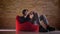 Closeup portrait of young korean male videoblogger playing video games online sitting in the bean bag