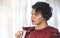 Closeup portrait of young latin client drinking red wine