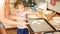 Closeup portrait of young mother teaching her toddler son making cookies. Child with parent baking desserts on baking