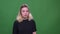 Closeup portrait of young pretty blonde caucasian female being confused and thoughtful looking at camera with background