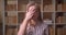 Closeup portrait of young pretty caucasian female student making a face palm being annoyed looking at camera in the