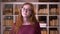 Closeup portrait of young redhead attractive caucasian female student in glasses dancing joyfully in front of the camera