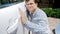 Closeup portrait of young smiling man checking car paint before buying new car