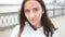 Closeup portrait of a young unhappy caucasian woman in front of a bridge near river. Happy young woman at river side