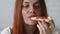 Closeup portrait of young woman holding tasty Italian slice of pizza ready to eat. Hungry woman, close up