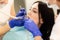 Closeup portrait of young woman patient, sitting in dentist chair. Doctor examines the teeth. Dental health prevention