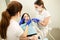 Closeup portrait of young woman patient, sitting in dentist chair. Doctor examines the teeth. Dental health prevention