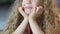 Closeup of positive curly kid lying on the floor and dreaming about presents