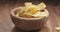 Closeup potato chip fall into bowl