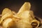 Closeup potato chips with herbs in wood bowl on rustic table