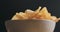 Closeup potato chips in white bowl low angle shot