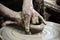 Closeup on potter man hands shaping ceramic craft