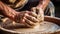 Closeup of potter& x27;s hands molds clay pot spinning on pottery wheel with special wooden tool