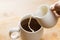 Closeup Pouring Cream into Cup of Hot Coffee.