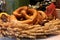 Closeup of pretzels and wheat ears behind the window of a bakery