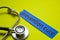 Closeup prevetion cure with stethoscope concept inspiration on yellow background