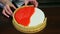 Closeup process of decorating of round glazed cheesecake by shortbread border