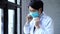Closeup of professional Asian doctor wearing a surgical face mask for protection against coronavirus COVID-19 outbreak