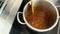 Closeup of professional chef man prepare gravy sauce with spices on oven at restaurant kitchen