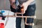 Closeup professional master plumber hands soldering copper pipes gas burner. Concept installation, plumbing replacement, solder