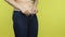 Closeup profile portrait overweight woman hands unable to close button on jeans pants