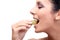 Closeup profile of young woman eating grapes