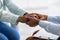 Closeup of psychotherapist supporting depressed young black woman, holding her hands at mental clinic, cropped