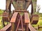 Closeup of a pumpjack for an oil well sitting idle in a field on Route 66.