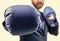 closeup punch of cropped businessman in boxing gloves ready for corporate business battle, knockout.