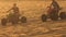 Closeup Quads Run Sand Drag Racing in White Dunes at Sunset