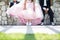 Closeup of a quinceanera/sweet 16 celebrant with pink dress and two boys on each side