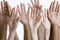 Closeup Of Raised Multiethnic Hands