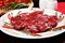 Closeup of raw beef medallions with rosemary, pepper and spices