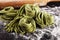 Closeup of raw homemade pasta tagliatelle. fresh italian traditional raw fresh green organic pasta