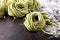 Closeup of raw homemade pasta tagliatelle. fresh italian traditional raw fresh green organic pasta