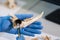 Closeup of rchaeologist working in natural research lab. Laboratory assistant cleaning animal bones. Close-up of hands