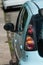 Closeup of rear light on blue Peugeot 107 parked in the street