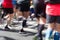 Closeup rear view on marathon runners legs and feet with motion