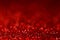 Closeup red glitter texture with blur bokeh light