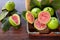 Closeup on red guava sliced with green leaf on rustic wooden background