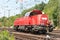 Closeup of a red modern freight locomotive during dayli