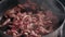 Closeup red pieces beef fried in frying pan. Sliced meat roasting with oil
