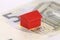 Closeup of a red replica house on a euro banknote - Real estate concept