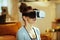 Closeup on relaxed woman at modern home meditating in VR gear