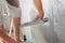 Closeup of repairman hand plastering a wall with putty knife or spatula.