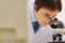 Closeup on researcher working with microscope