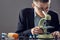 Closeup on researcher working with microscope in laboratory. A guy with glasses and a jacket is working with a